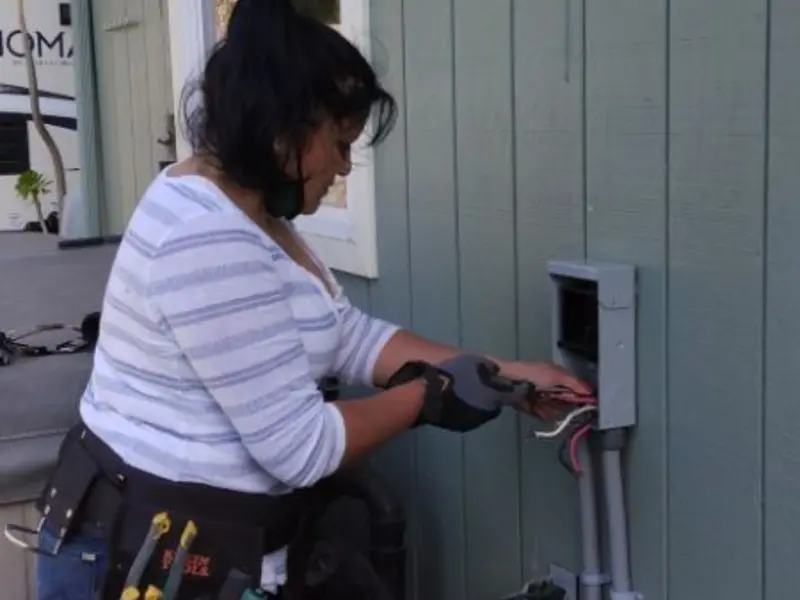 Licensed electrician wiring an exterior subpanel in Jacksonville Beach
